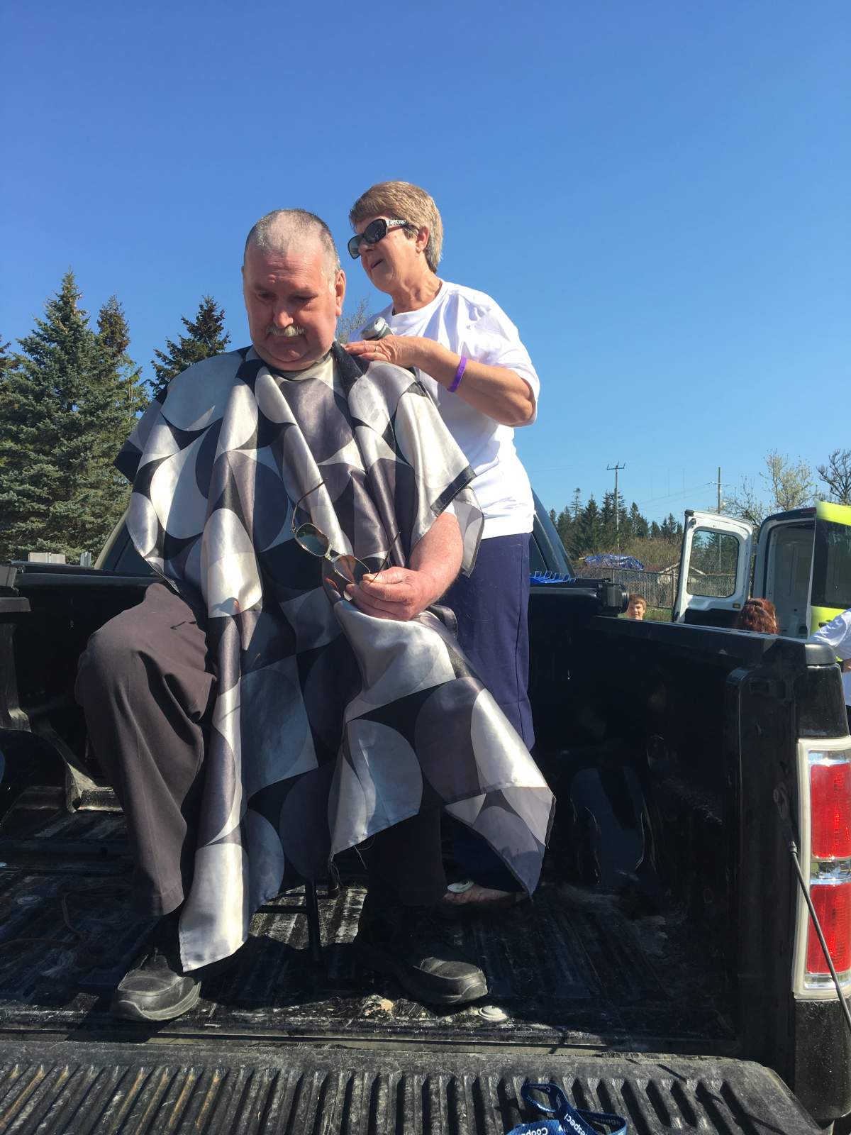 Peter Beacock, chair of the Sicmoe County District School Board, has his head shaved at Guthrie Public School’s Bike-a-Thon event.