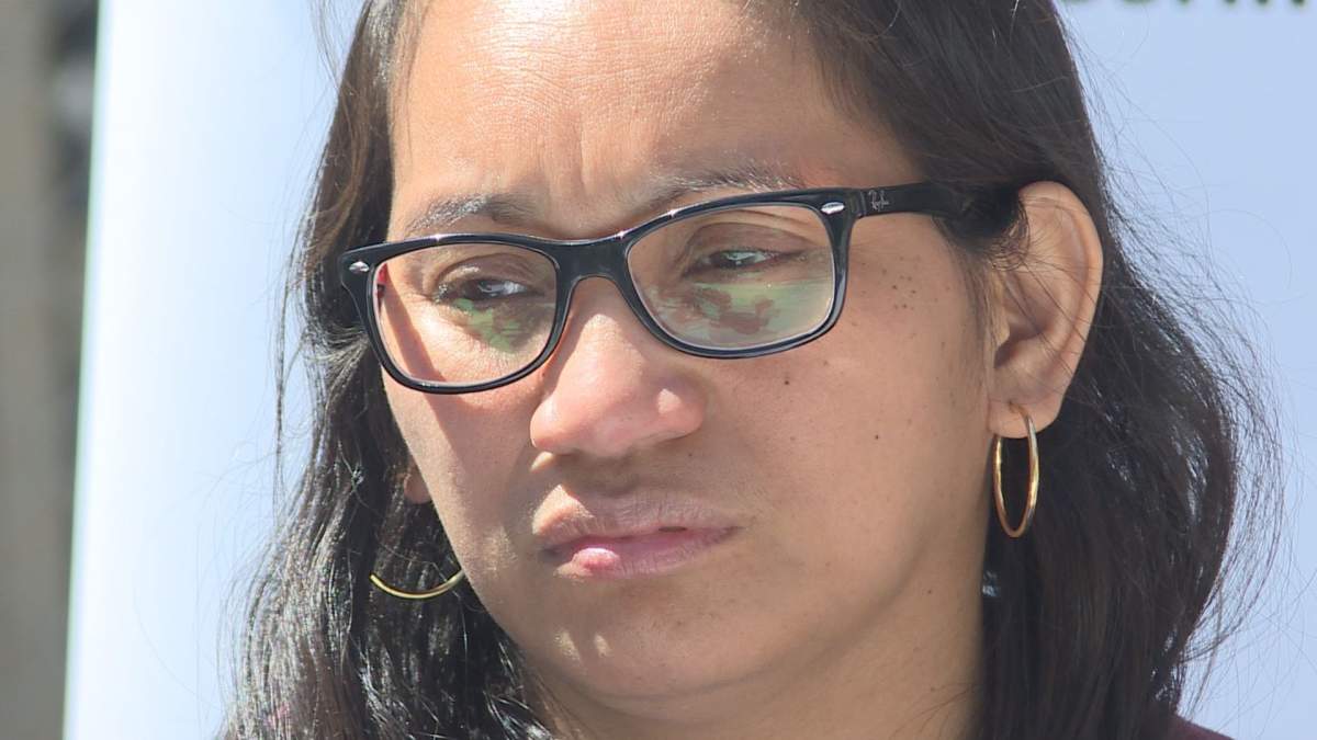 Gelyn Dasoc holds back tears during a press conference. 