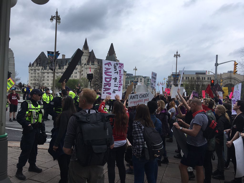 Pro-life marchers and pro-choice marchers meet in front of the war memorial on Elgin Street Thursday.