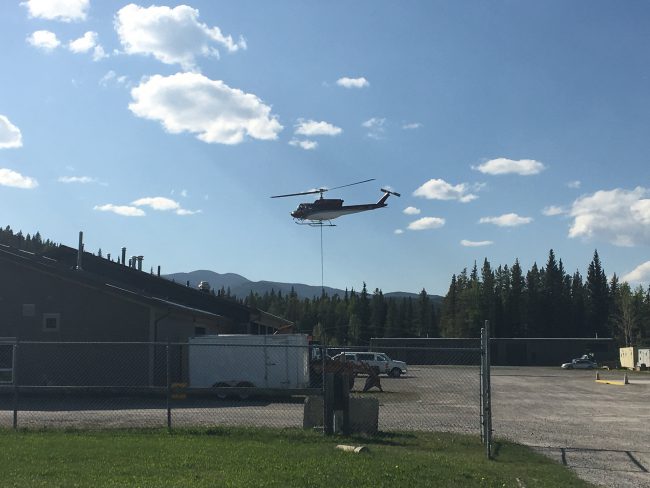 Helicopters depart from Elbow Valley Fire Station to assist in firefighting efforts.