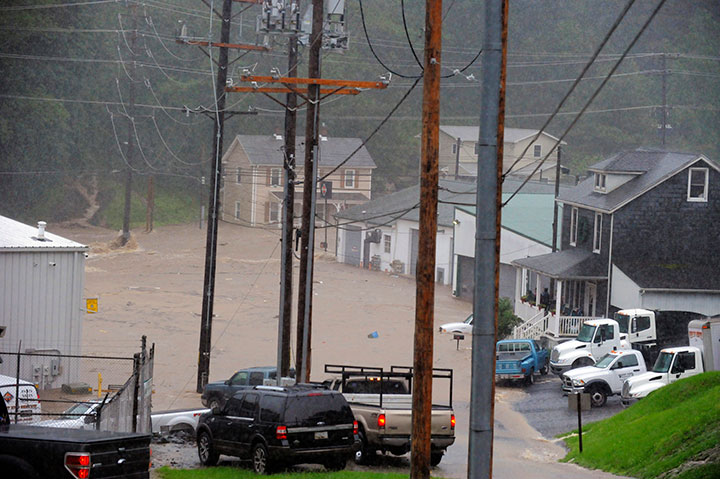 Floodwaters rush through part of Ellicott City, Md., Sunday, May 27, 2018.