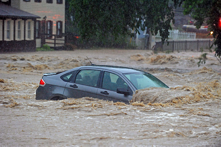 A parked car flooded in a lot near Main Street and Ellicott Mills Road as a heavy storm caused flash floods in Ellicott City, Md., Sunday, May 27, 2018.