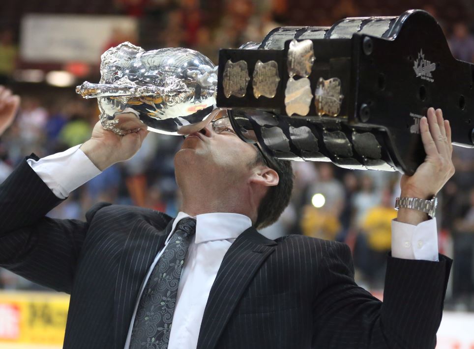 Shawinigan Cataractes head coach Eric Veilleux raises and kisses the Memorial Cup trophy as he celebrates their win over London Knights at Memorial Cup final game action Sunday, May 27, 2012 in Shawinigan Que.. 