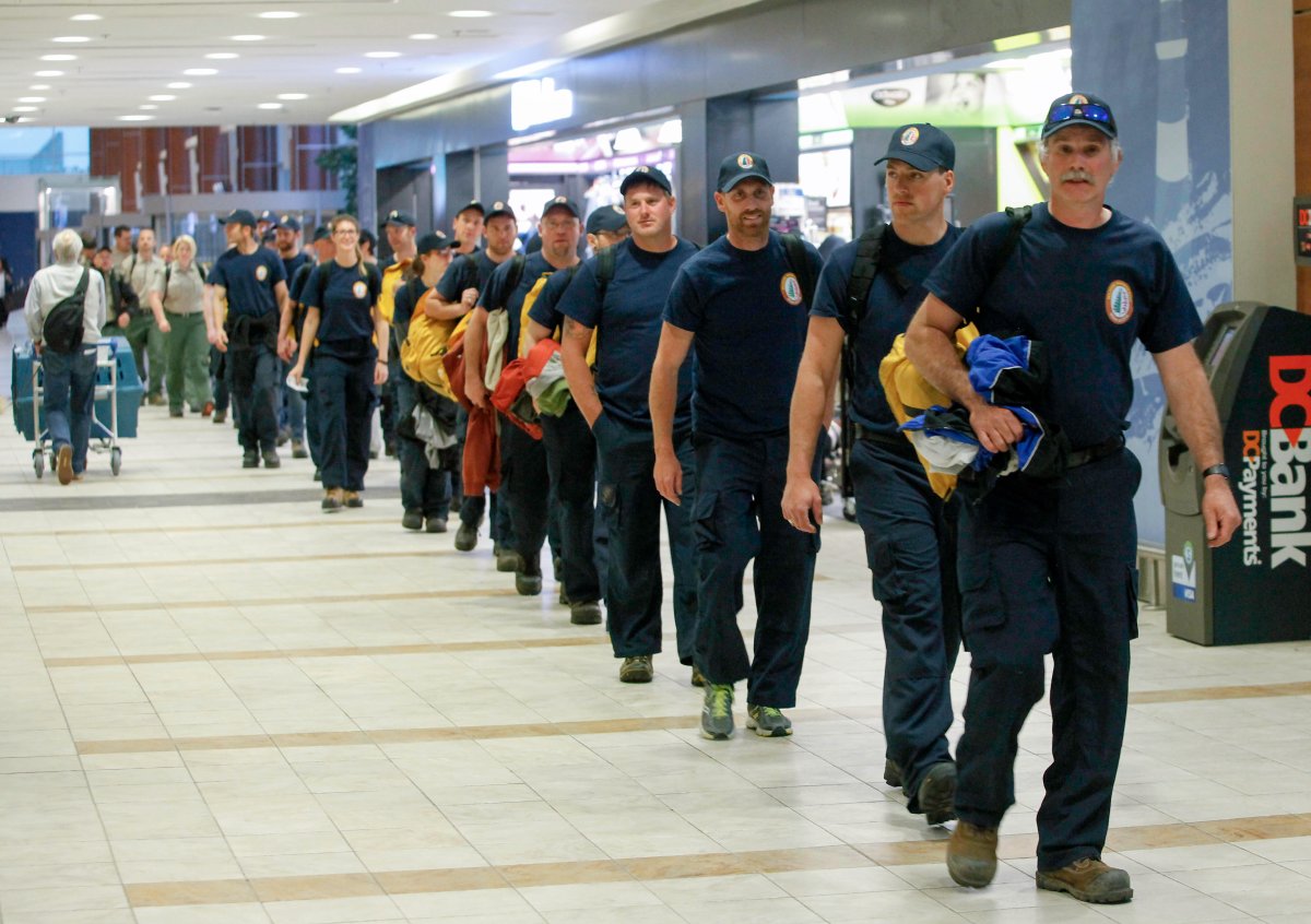 Firefighters arrive at Halifax Stanfield International Airport before heading to Alberta on Saturday, May 26, 2018. 