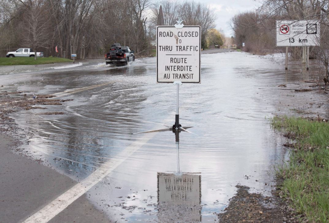 New Brunswick Highway 105 south of Fredericton in Maugerville is closed to traffic except for local residents due to flooding from the St. John River in Fredericton, N.B., on Sunday, May 7, 2017. Officials were restricting driving on the roads to only trucks late in the afternoon due to the fast moving water over the roads. NBEMO is advising people living near the St. John River and its tributaries to remain on alert in the coming days as water levels are near or above flood stage in many regions. 