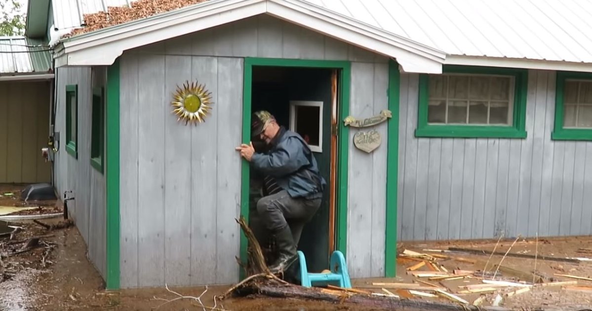 Shawn McNee surveys the damage at his family flood-ravaged cottage in Chipman, N.B. 