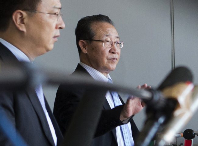 North Korea’s First Vice Foreign Minister Kim Kye Gwan, right, waves as he arrives at the Capital airport in Beijing, China, June 18, 2013.