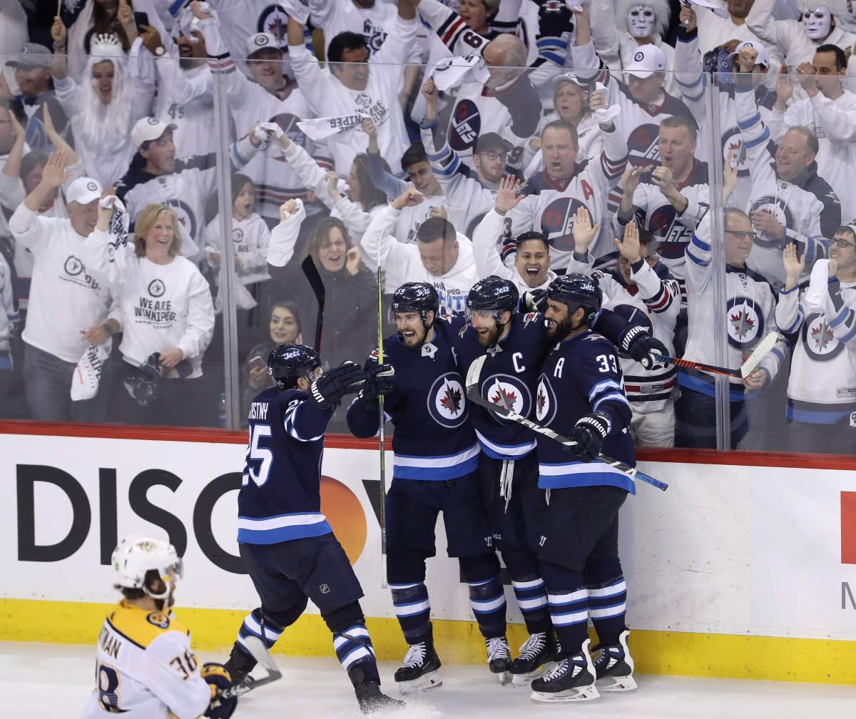 Winnipeg Jets' Paul Stastny (25), Mark Scheifele (55), Blake Wheeler (26) and Dustin Byfuglien (33) celebrate after Wheeler scored against the Nashville Predators during third period NHL hockey playoff action in Winnipeg, Tuesday, May 1, 2018.