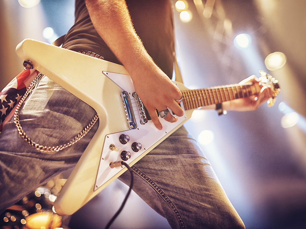 A guitarist plays on stage.