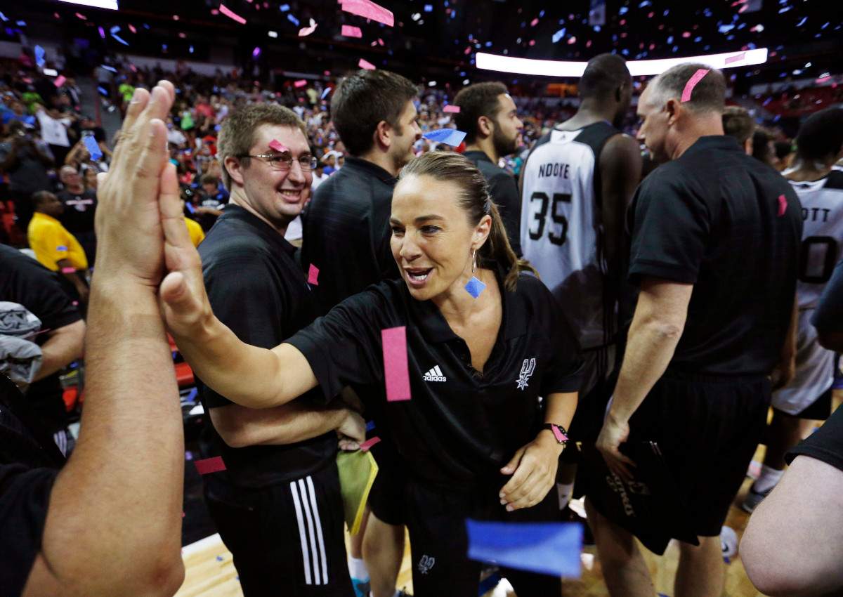 San Antonio Spurs coach Becky Hammon celebrates with her team after they defeated the Phoenix Suns in an NBA summer league championship basketball game Monday, July 20, 2015, in Las Vegas.