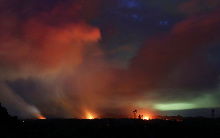 Lava shoots into the night sky from active fissures on the lower east rift of the Kilauea volcano, Tuesday, May 15, 2018 near Pahoa, Hawaii.