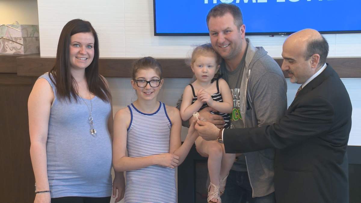 The Prystupa family receives the key to their prize home. 