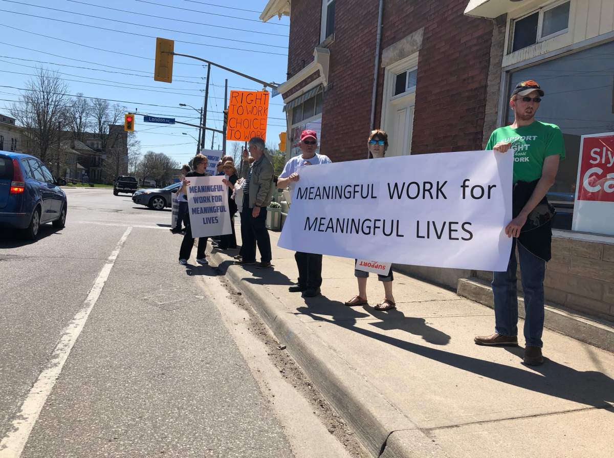 Protesters rally outside the office of Sly Castaldi, Guelph's Liberal candidate in the upcoming provincial election.