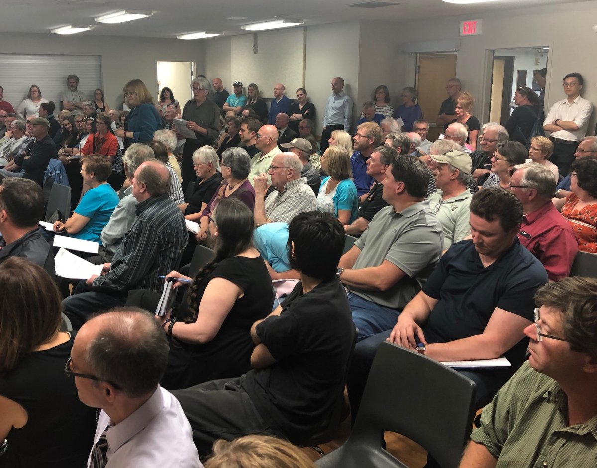 Residents from Guelph-Eramosa Township packed into a community centre to hear a proposal to build a massive glass plant in their community.