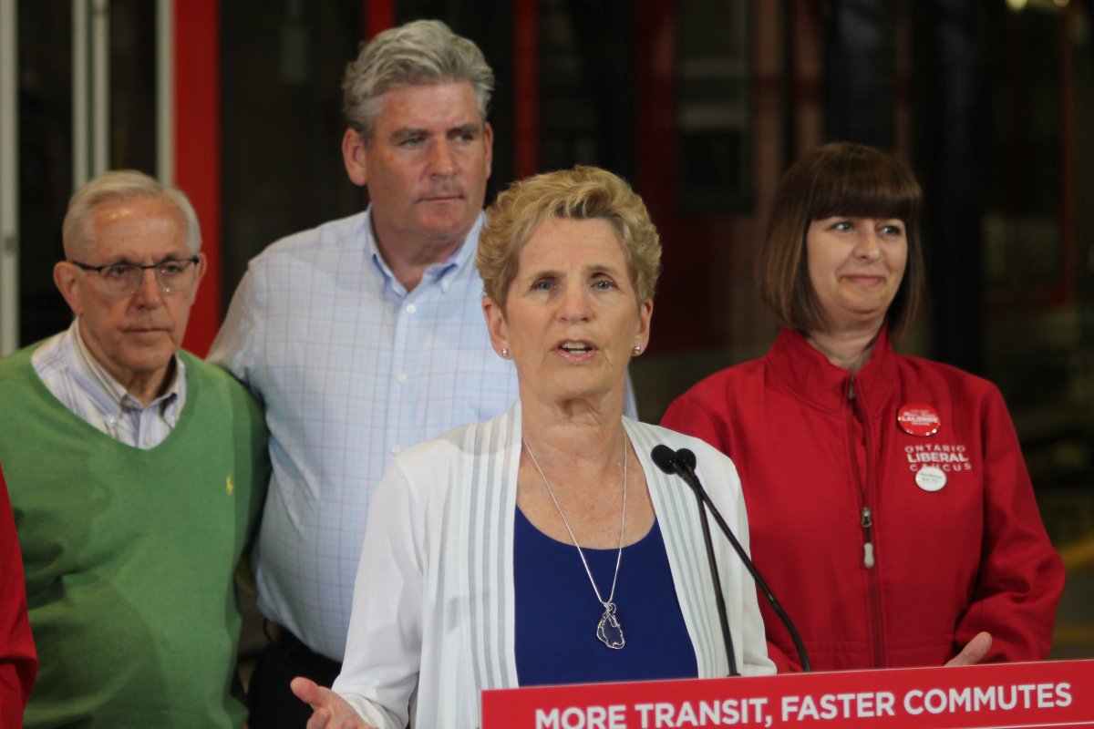 Ontario Liberal Leader Kathleen Wynne speaks to reporters Thursday alongside Ottawa Liberal Party candidates.