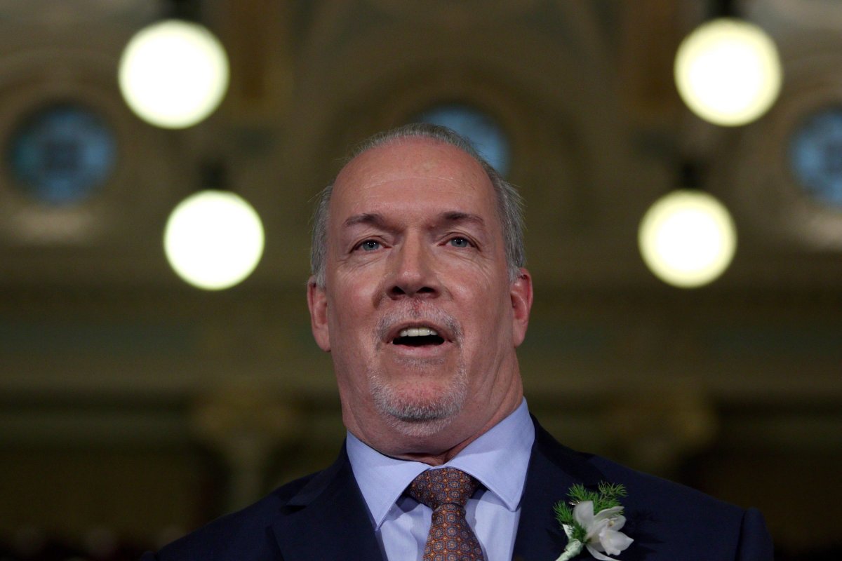 Premier John Horgan answers questions from the media following the speech from the throne in the legislative assembly in Victoria, B.C., on Tuesday, February 13, 2018. THE CANADIAN PRESS/Chad Hipolito.