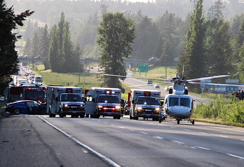 An air ambulance lands on Highway 1 in Langley on Thursday.