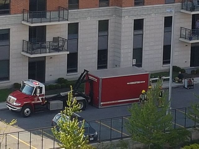 A photo from the scene shows a large container brought by Kingston Fire to deal with the spill.