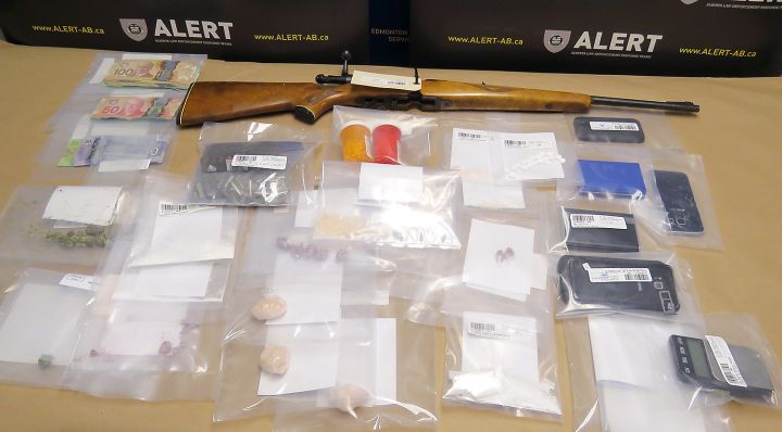 Two people have been charged after drugs, a rifle and cash were seized from a home in Lethbridge on Thursday, May 24, 2018.