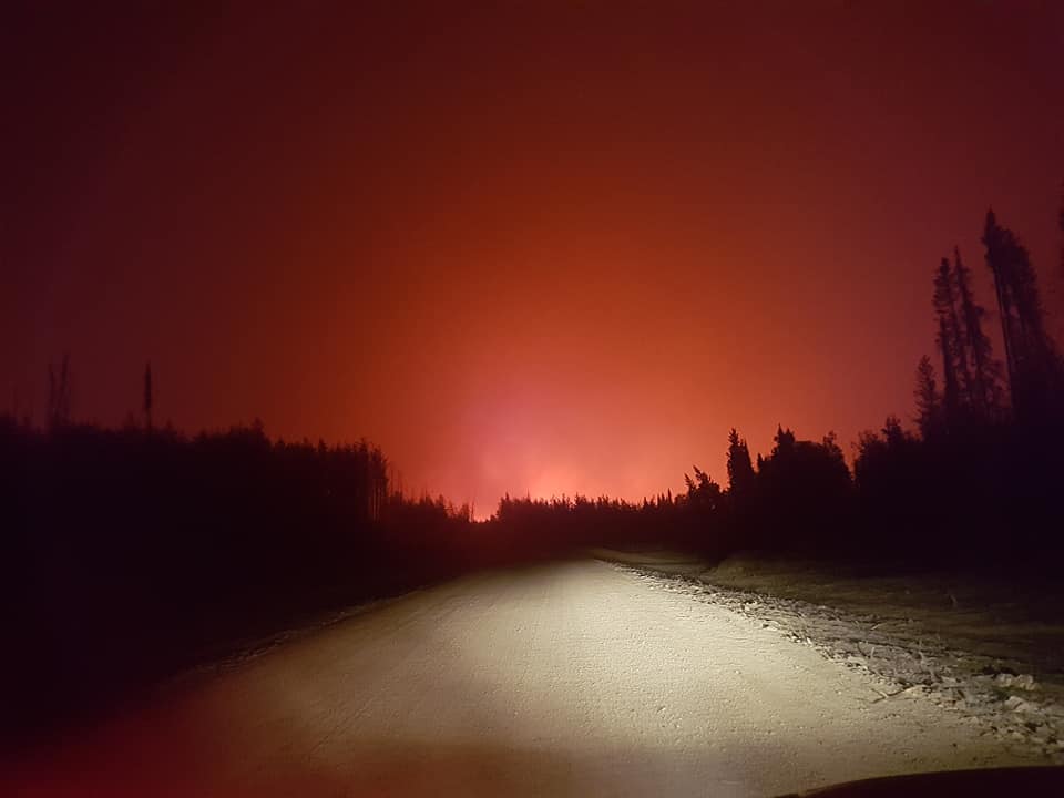 The night sky glows red as wildfires threaten Little Grand Rapids May 23. 
