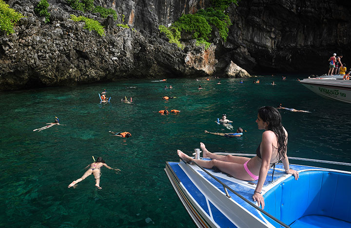This photo taken on April 8, 2018 shows tourists snorkelling in the water nearby Maya Bay, on the southern Thai island of Koh Phi Phi.