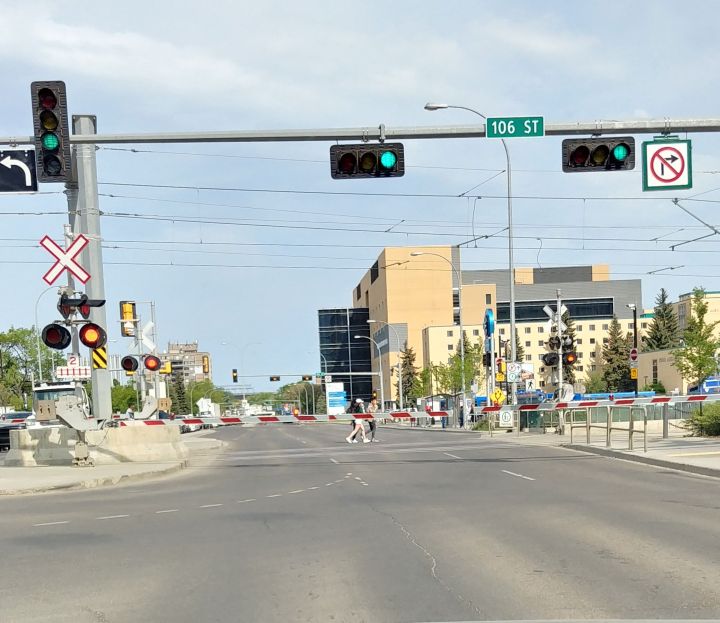 A photo posted to Reddit shows the Metro LRT crossing arms down at 111 Avenue and 106 Street while the light is green.
