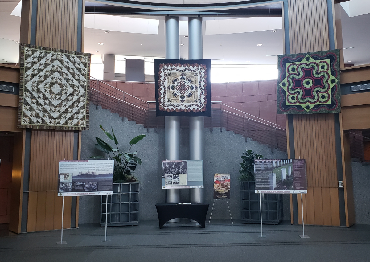 'Three Pieces in a Pod' (centre) is the cover quilt at this year's Mennonite Relief sale quilt auction.