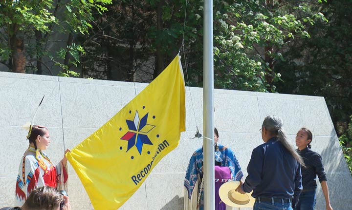 A Reconciliation flag is raised to honour victims and survivors of the ’60s Scoop and residential schools.