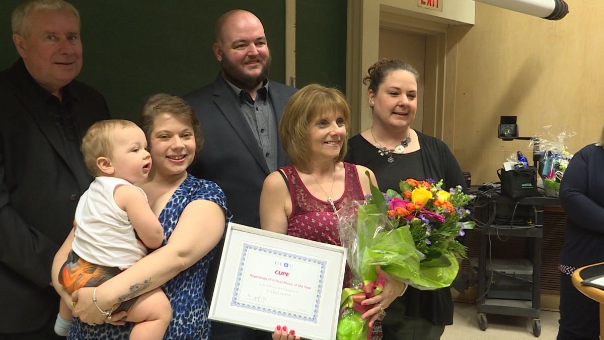 Susan Cooper poses with friends, family and colleagues after winning the Nurse of the Year award from CUPE and the Ontario Council of Hospital Unions.