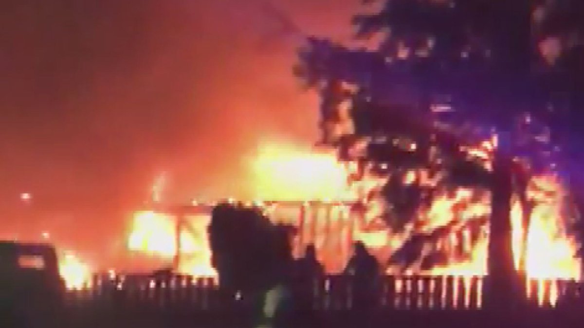 Flames engulf a house in Kelowna Thursday night and are caught on video by neighbours.  Check out video below.