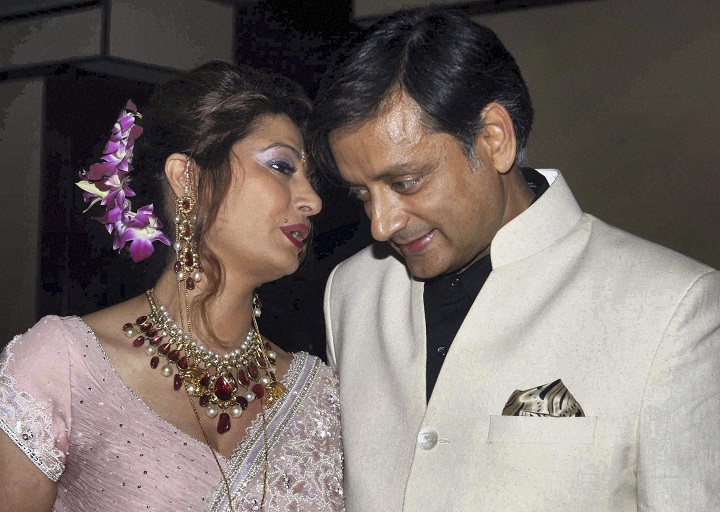 In this Sept. 4, 2010 file photo, former Indian Junior Foreign Minister Shashi Tharoor listens to his wife Sunanda Pushkar at their wedding reception in New Delhi, India. 