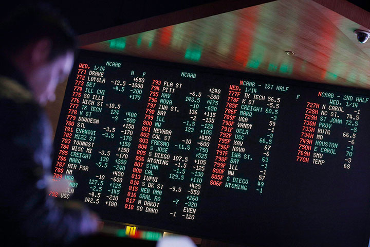 In this Jan. 14, 2015 file photo, odds are displayed on a screen at a sports book owned and operated by CG Technology in Las Vegas. 