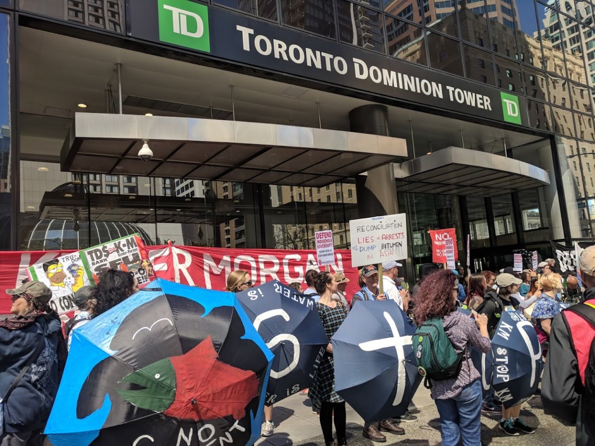 Demonstrators gather outside TD Tower in Vancouver to call for the bank to divest from Kinder Morgan.
