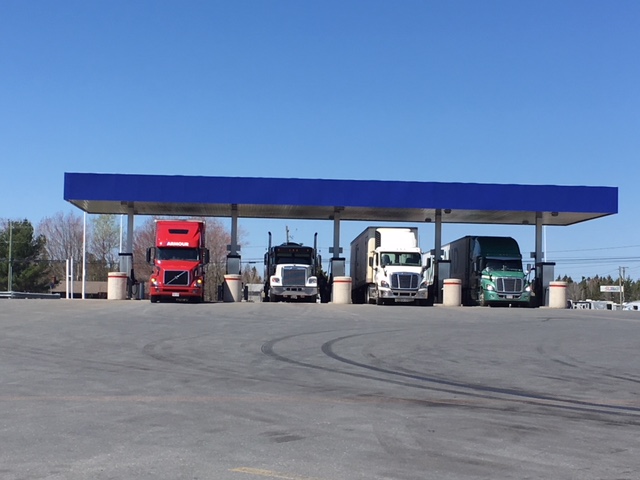 Several trucks fuel up at a truck stop outside of Fredericton.