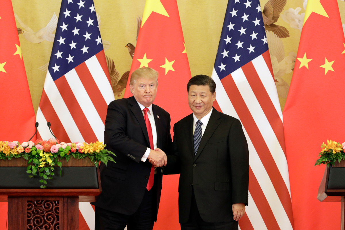 U.S. President Donald Trump, left, and Xi Jinping, China's president, shake hands during a news conference at the Great Hall of the People in Beijing, China, on Thursday, Nov. 9, 2017. 