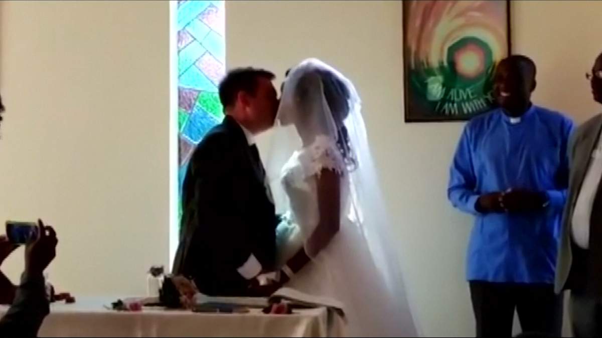 Jamie Fox, left, and Zanele Ndlovu kiss during their wedding on May 5, 2018, held days after a crocodile attacked them
