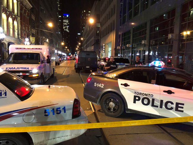 Police cars and ambulances at the scene of a suspected shooting near Yonge and Wellington Streets in Toronto, May 20, 2018.