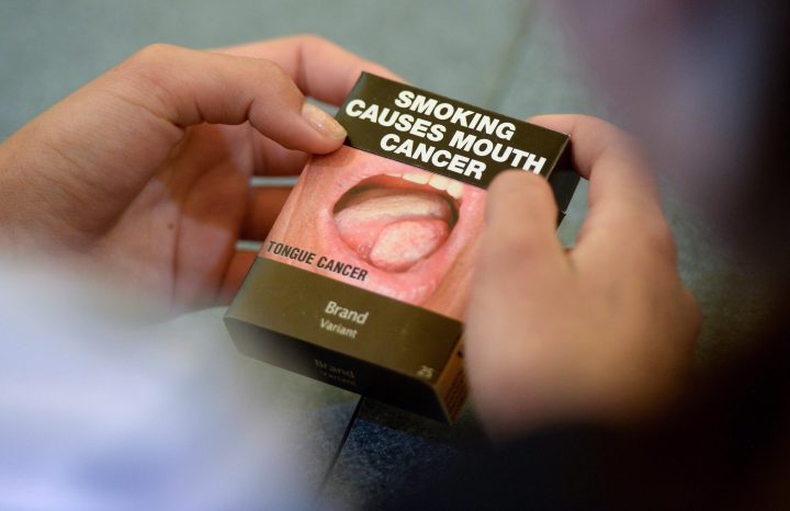 Local Ottawa high school students look at plain cigarette packaging examples, on World No Tobacco Day, prior to meeting with Minister of Health Jane Philpott in Ottawa on Tuesday, May 31, 2016. Philpott officially launched public consultations on plain packaging requirements for tobacco products. THE CANADIAN PRESS/Sean Kilpatrick.