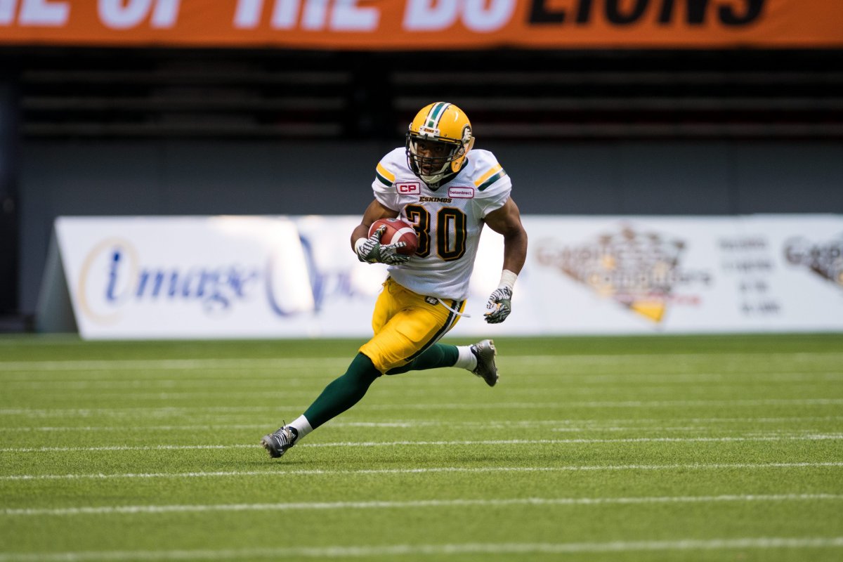 Edmonton Eskimos running back John White (30) runs the ball during CFL action between the Eskimos and Lions in Vancouver, B.C., Saturday, June 24, 2017.  