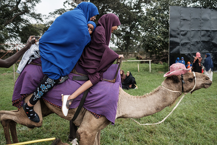 A family takes a camel ride after Eid al-Fitr prayers in Nairobi, Kenya, on June 15, 2018.