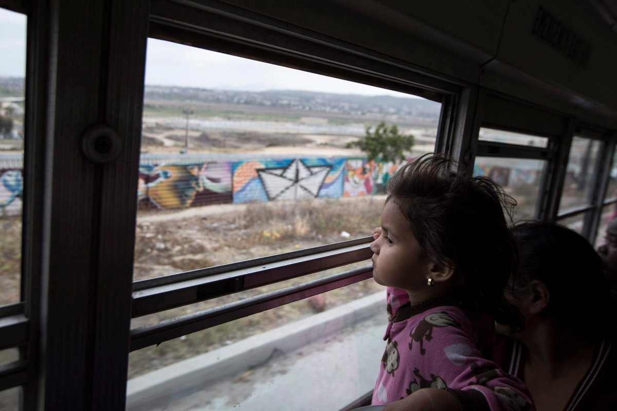 A Central American child who is traveling with a caravan of migrants.