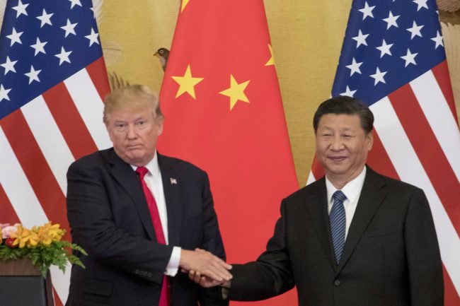FILE - In this Nov. 9, 2017 file photo, President Donald Trump and Chinese President Xi Jinping shake hands during a joint statement to members of the media in Beijing, China.