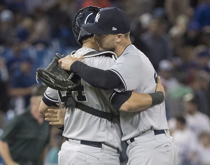 New York Yankees pitcher Chasen Shreve is embraced by catcher Gary Sanchez after they defeated the Toronto Blue Jays in their American League MLB baseball game in Toronto on Tuesday.