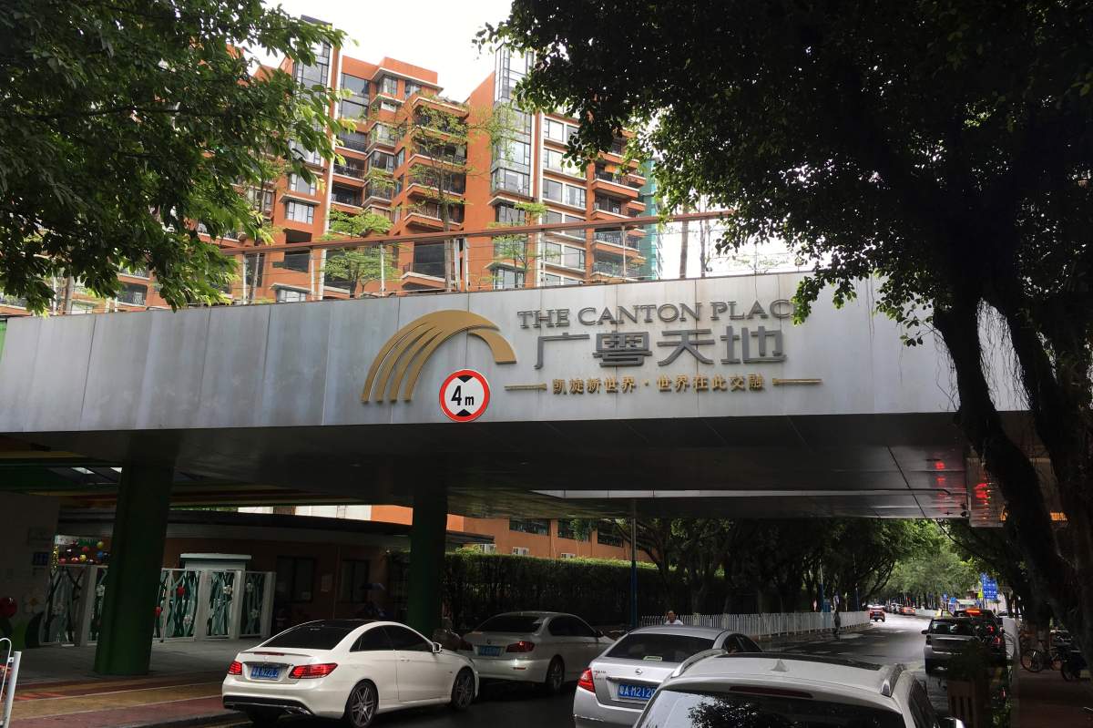 Vehicles pass by high-rise apartment buildings in The Canton Place where U.S. government workers experienced unexplained health issues in Guangzhou, southern China's Guangdong province, Thursday, June 7, 2018. 