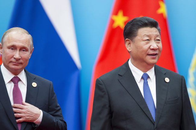 Chinese President Xi Jinping and Russian President Vladimir Putin walk to attend talks at the Shanghai Cooperation Organization (SCO) Summit in Qingdao, China, June 10, 2018. 

