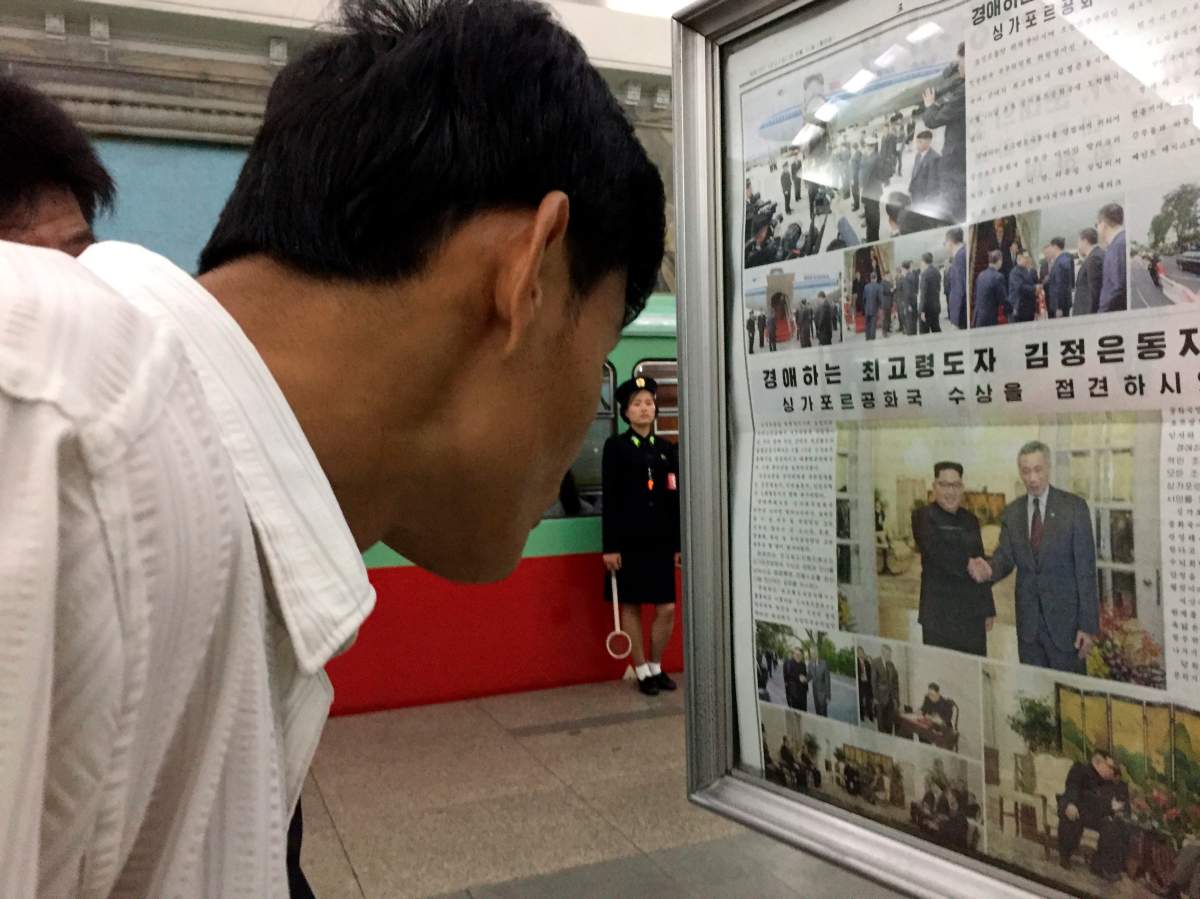 Commuters read the news of North Korean leader Kim Jong UnÄôs arrival in Singapore ahead of his summit with President Donald Trump at a Pyongyang subway station in Pyongyang, North Korea Monday June 11, 2018. 
