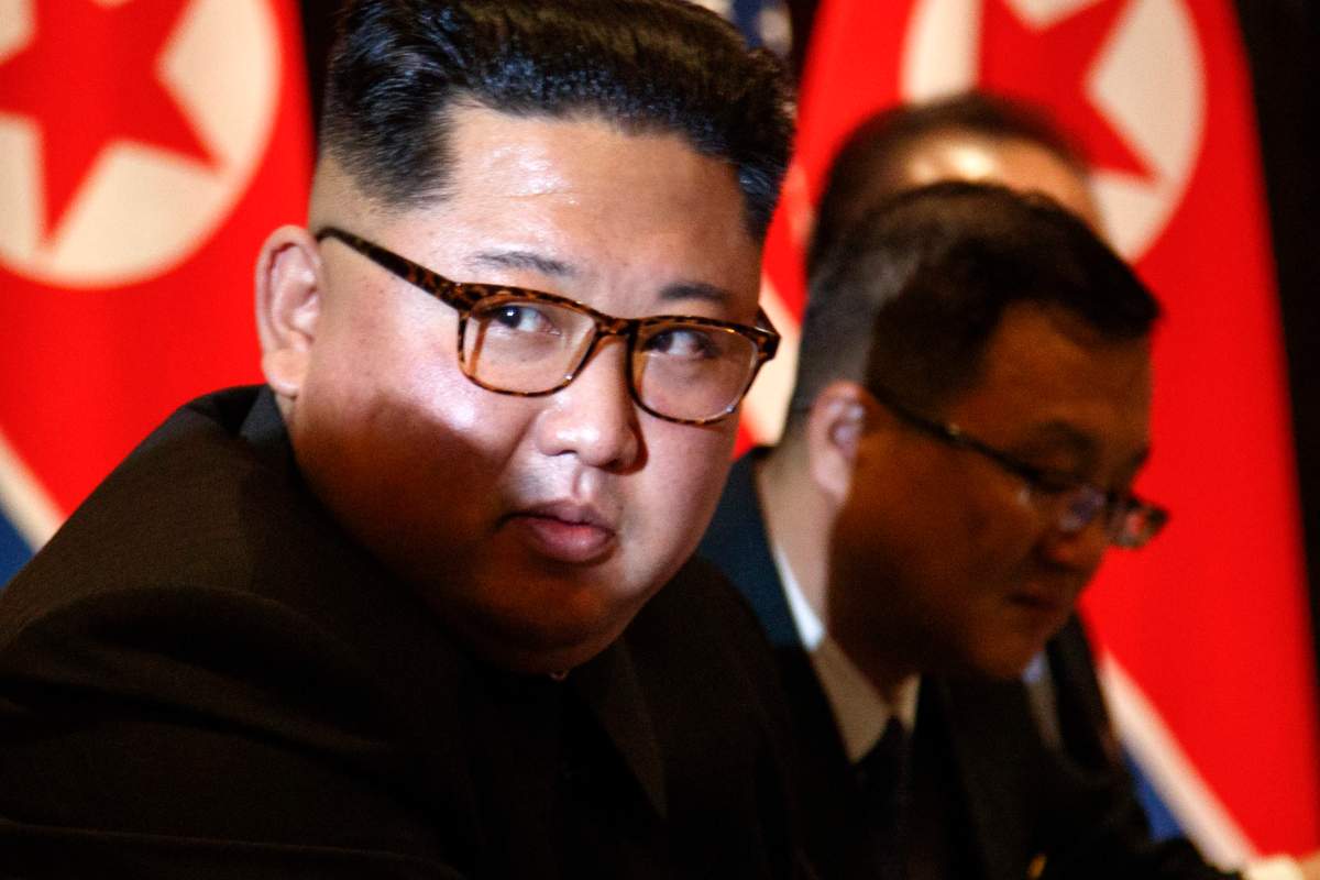 North Korea leader Kim Jong Un looks at the news media during a photo session during a expanded bilateral meeting with U.S. President Donald Trump at the Capella resort on Sentosa Island Tuesday, June 12, 2018 in Singapore.