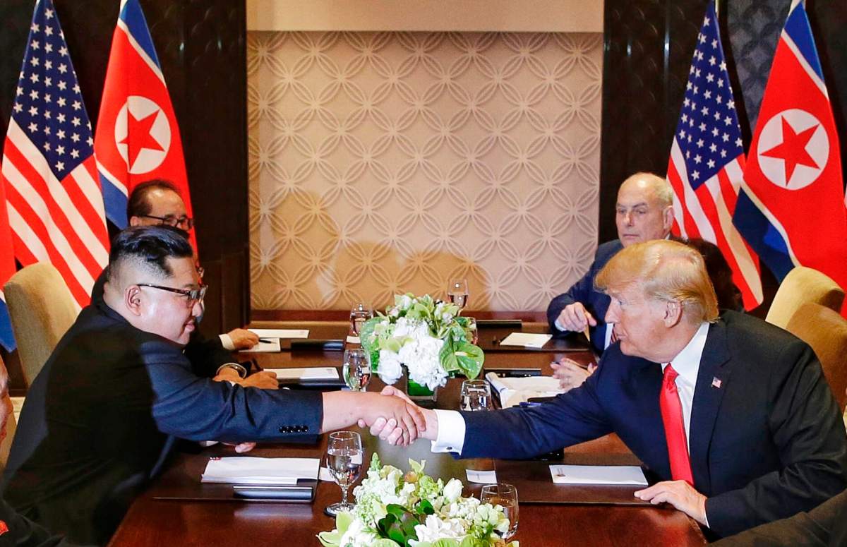U.S. President Donald Trump shakes hands with North Korean leader Kim Jong Un during their meeting at the Capella resort on Sentosa Island Tuesday, June 12, 2018, in Singapore.