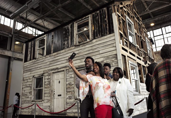 Cheryl Galloway, of Providence, R.I., uses a mobile phone to take a photo with family members in front of the rebuilt house of Rosa Parks at the WaterFire Arts Center in Providence, R.I. 