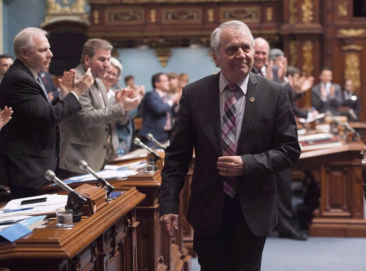 In this file photo, Parti Québécois MNA François Gendron, walks back to his seat as members of the National Assembly applaud for being an elected member for the last 40 years in Quebec City on Tuesday, November 15, 2016. Gendron will be retiring from politics this fall. Sunday, june 17, 2018.